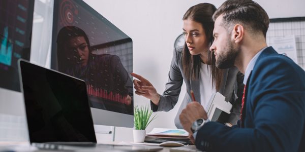 selective-focus-of-information-security-analysts-using-charts-on-computer-monitors-while-working-in.jpg
